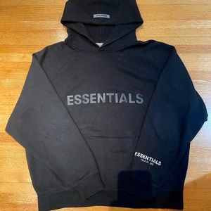 Black Fear of God Essentials hoodie.